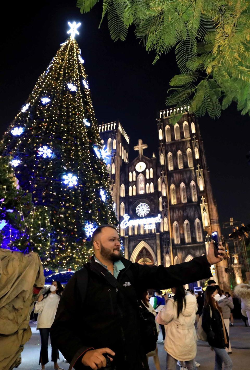 Một du khách nước ngoài gọi trực tuyến cho người thân về không khí Giáng sinh tại Hà Nội. (Ảnh: Nhật Anh/TTXVN)