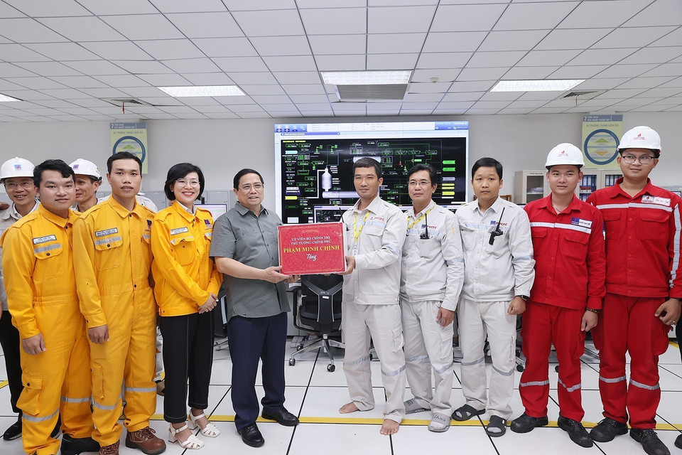 Thủ tướng Phạm Minh Chính tặng quà cho kỹ sư, công nhân Cụm Công nghiệp Khí-Điện-Đạm Cà Mau. (Ảnh: Dương Giang/TTXVN)