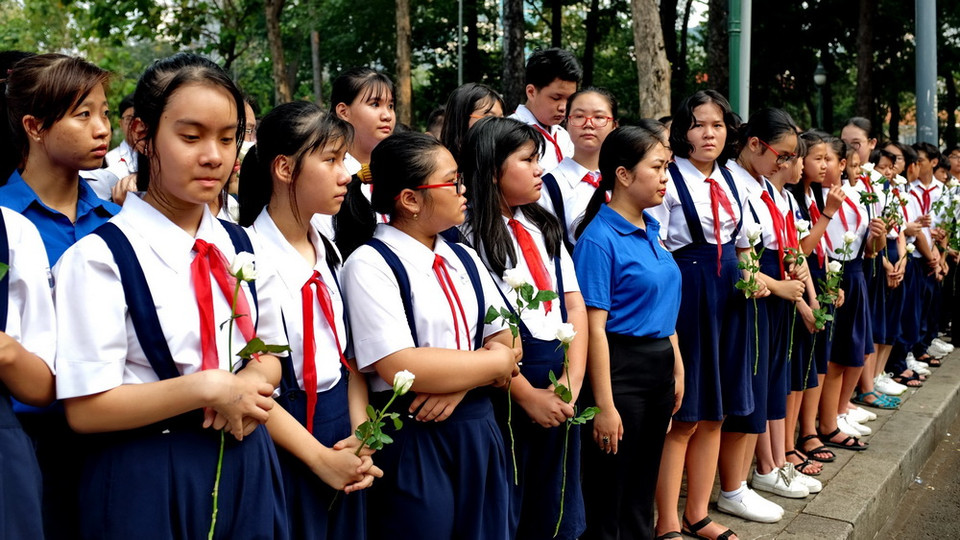 Các em học sinh thành phố dự tiễn đưa nguyên Thủ tướng Phan Văn Khải về nơi an nghỉ cuối cùng. (Ảnh: Thế Anh/TTXVN)