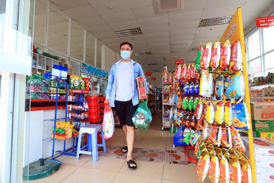 Công nhân Phạm Văn Việt (công nhân Công ty Canon Việt Nam, khu công nghiệp Thăng Long) mua lương thực, thực phẩm tại siêu thị trong khu nhà ở công nhân thôn Bầu, xã Kim Chung, Đông Anh. (Ảnh: Phan Tuấn Anh/TTXVN)