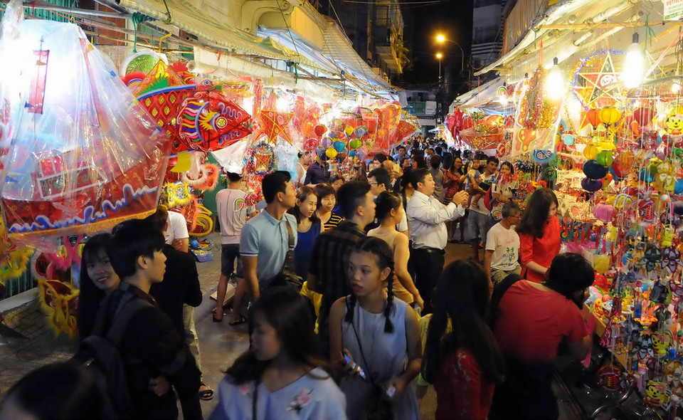 Các em thiếu nhi thích thú lựa chọn lồng đèn. (Ảnh: An Hiếu/TTXVN)