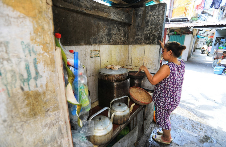 Hàng chục năm nay, những hộ dân dưới tầng 1 vẫn phải nấu ăn ngoài trời vì trong nhà là trần gỗ rất nguy hiểm có thể xảy ra hỏa hoạn bất cứ lúc nào. (Ảnh: Thành Đạt/TTXVN)