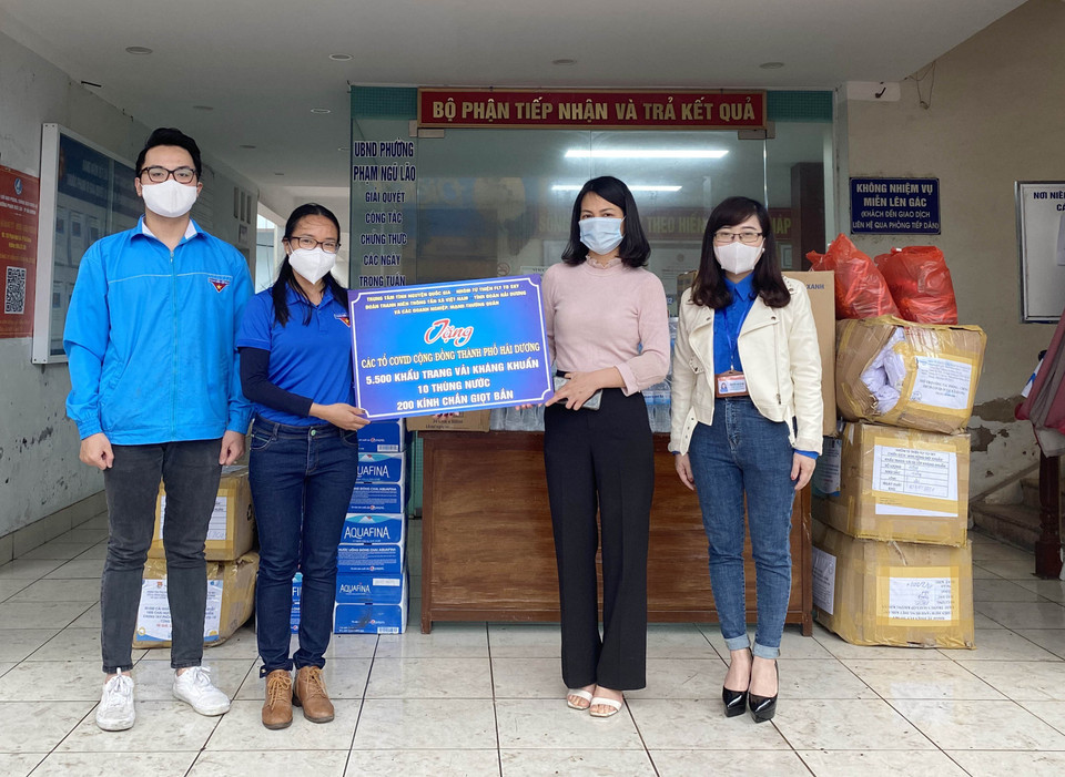 Đại diện Cơ quan thường trú TTXVN tại Hải Dương trao tặng UBND phường Phạm Ngũ Lão (thành phố Hải Dương) 5.500 khẩu trang vải kháng khuẩn, 200 kính chắn giọt bắn, 10 thùng nước khoáng đóng chai. (Ảnh: TTXVN)