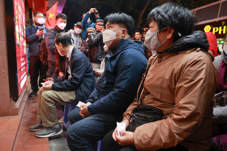 Người dân áo quần như nêm, co ro chờ đợi trong trời rét đậm. (Ảnh: Minh Hiếu/Vietnam+)