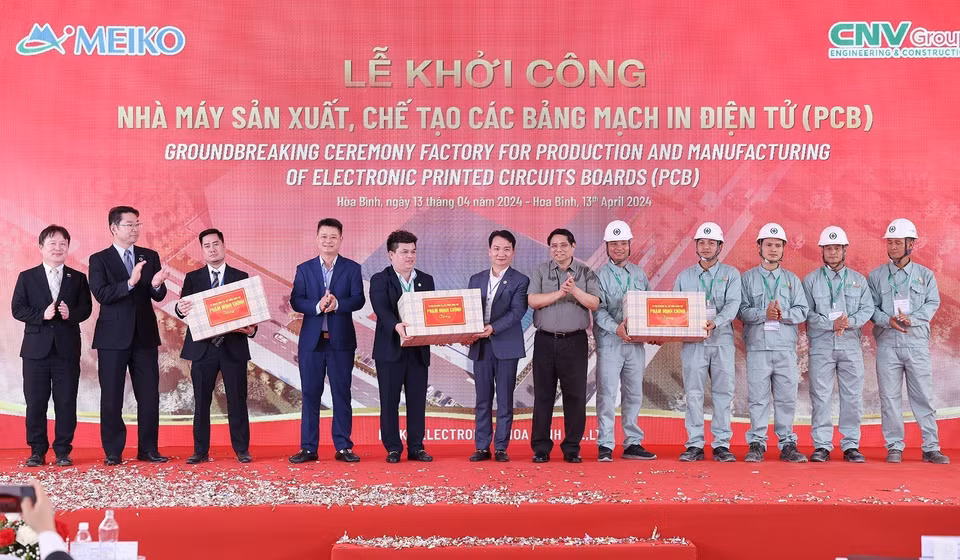 Thủ tướng Phạm Minh Chính tặng quà cho các đơn vị thi công xây dựng Nhà máy sản xuất, chế tạo các loại bảng mạch in điện tử (PCB) tại Hòa Bình. (Ảnh: Dương Giang/TTXVN)