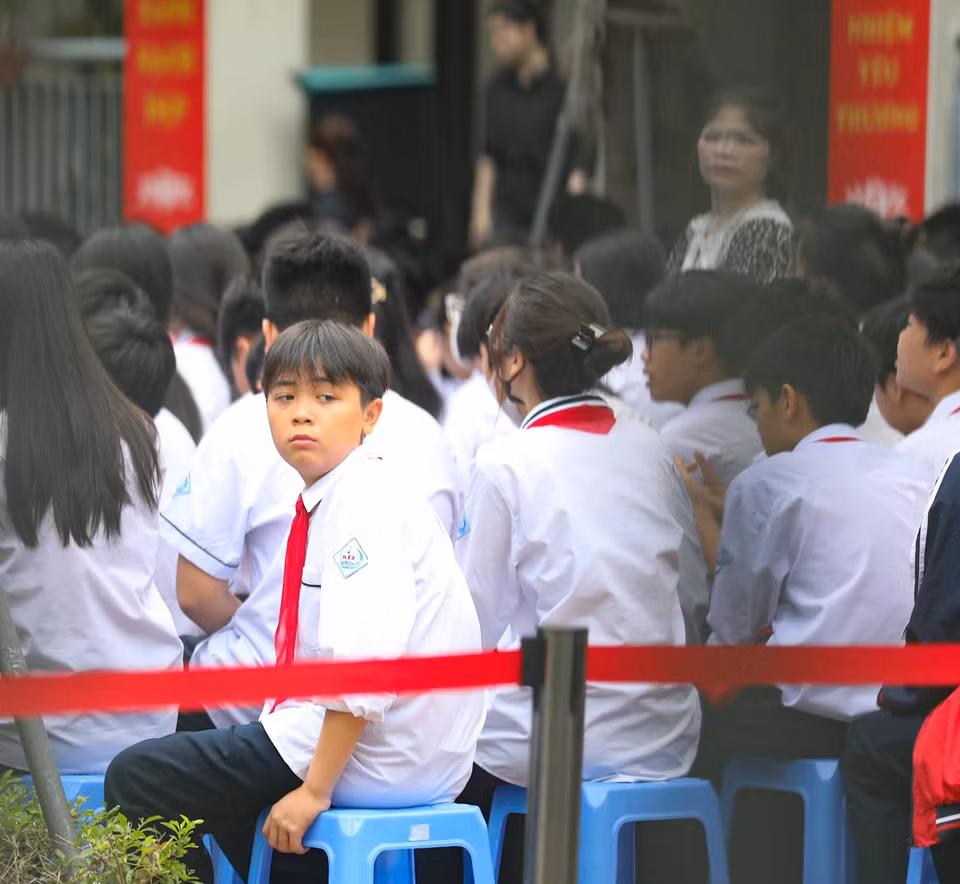Học sinh trường Trung học Cơ sở Khương Đình chưa hết bàng hoàng trước sự ra đi đột ngột của các bạn học sinh cùng trường trong vụ cháy chung cư mini tại phố Khương Hạ (Thanh Xuân, Hà Nội). (Ảnh: Thanh Tùng/TTXVN)