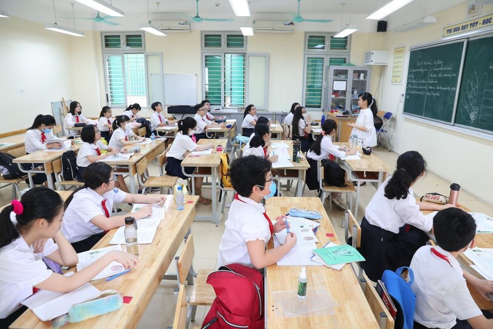 Một số học sinh trường THCS Trưng Vương vẫn thực hiện đeo khẩu trang trong lớp học dù không bắt buộc. (Ảnh: Thành Đạt/TTXVN)