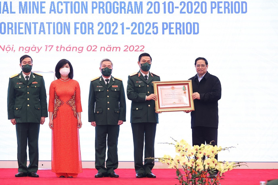Thủ tướng Phạm Minh Chính trao Huân chương Bảo vệ Tổ quốc hạng Ba cho Trung tâm Hành động bom mìn quốc gia Việt Nam. (Ảnh: Dương Giang/TTXXVN)