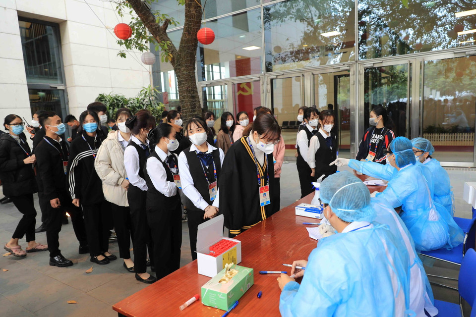 Nhân viên y tế lấy mẫu xét nghiệm các nhân viên Trung tâm Hội nghị Quốc gia tham gia phục vụ Đại hội XIII của Đảng, sáng 29/1. (Ảnh: TTXVN)