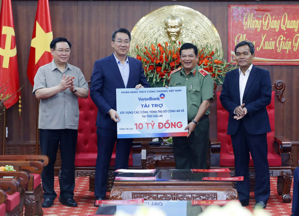 Chủ tịch Quốc hội Vương Đình Huệ chứng kiên đại diện ngân hàng Công Thương Việt Nam trao tặng tỉnh Gia Lai 10 tỷ đồng để xây dựng trụ sở công an xã. (Ảnh: Nhan Sáng/TTXVN)