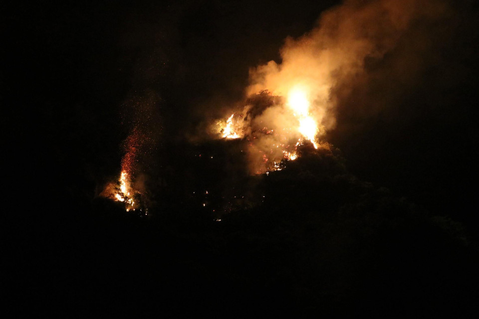 Nhiều đám cháy ở lưng chừng núi khiến việc tiếp cận gặp khó khăn. (Ảnh: Ninh Đức Phương/TTXVN)