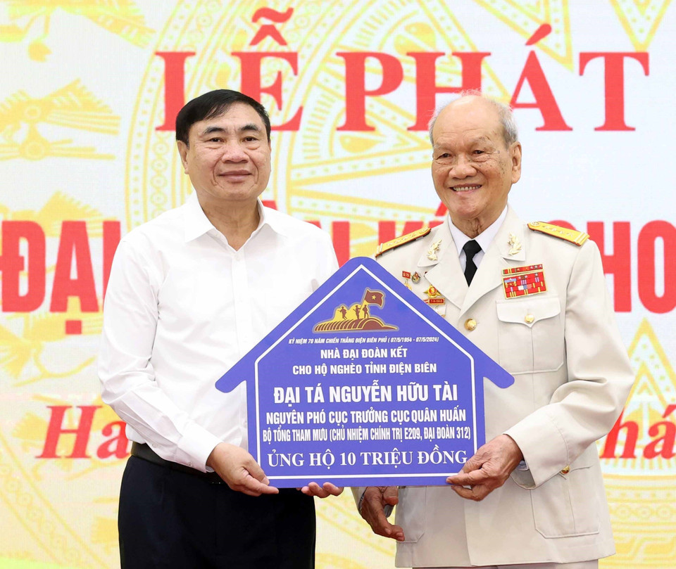 Đại tá Nguyễn Hữu Tài trao ủng hộ làm nhà Đại đoàn kết cho hộ nghèo tỉnh Điện Biên. (Ảnh: Thống Nhất/TTXVN)