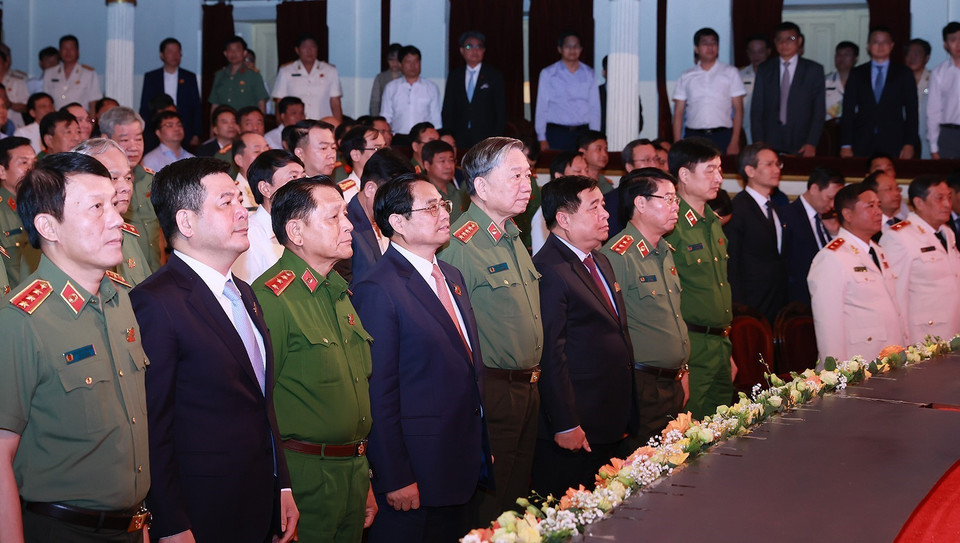 Thủ tướng Phạm Minh Chính và các đại biểu thực hiện nghi thức chào cờ tại lễ kỷ niệm 70 năm Ngày truyền thống lực lượng An ninh Kinh tế. (Ảnh: Dương Giang/TTXVN)