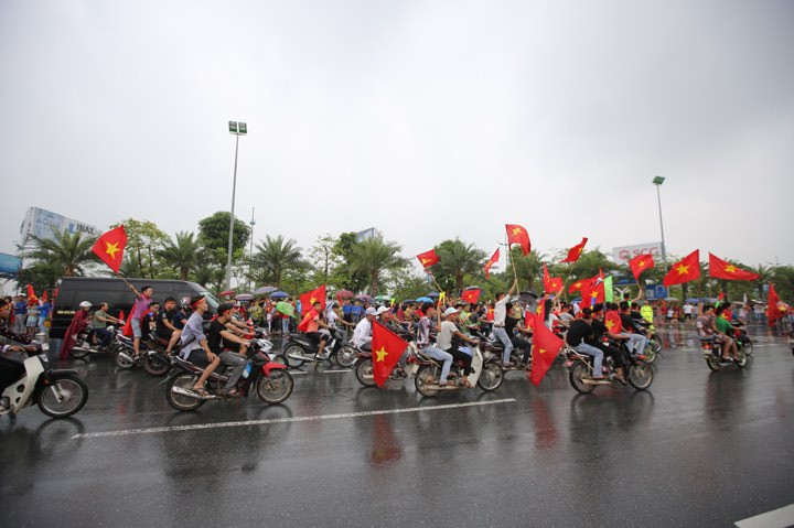 Đoàn diễu hành trên Đại lộ Võ Nguyên Giáp để tạo không khí nóng trước thời khắc chuyên cơ chở đội tuyển Olympic Việt Nam đặt chân xuống Nội Bài. (Ảnh: PV/Vietnam+)