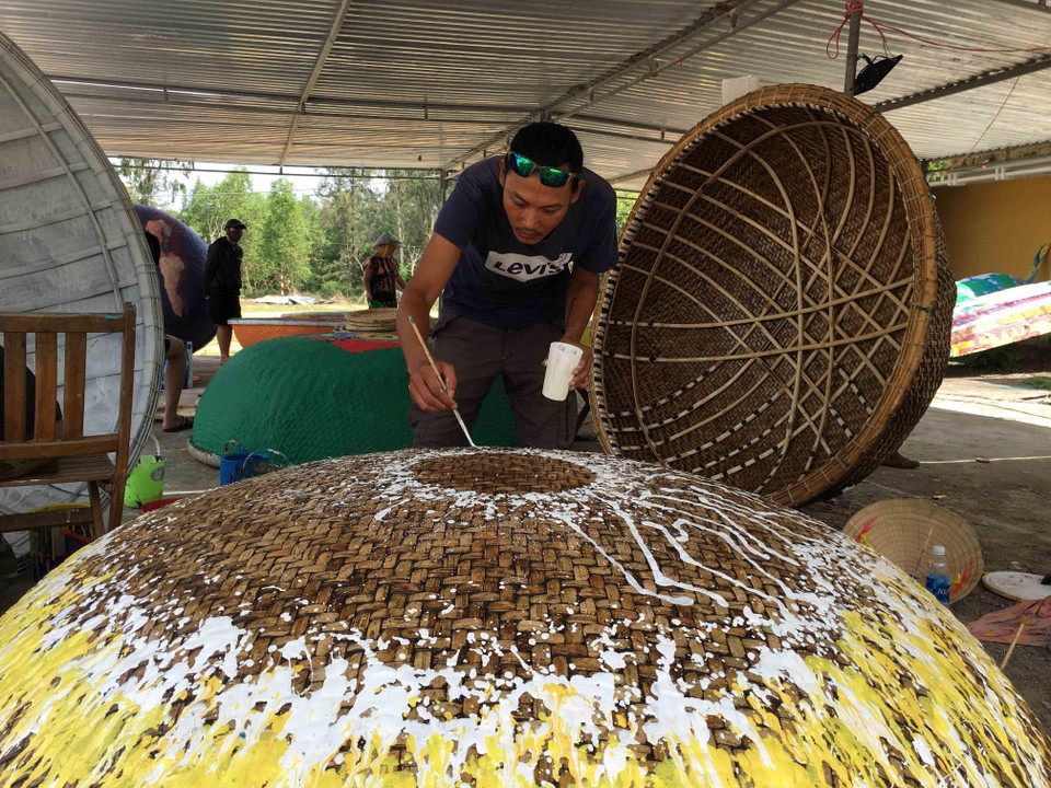 Những tác phẩm hội họa nhiều màu sắc, độc đáo được các họa sỹ thể hiện trên những chiếc thuyền thúng. (Ảnh: Đỗ Trưởng/TTXVN)