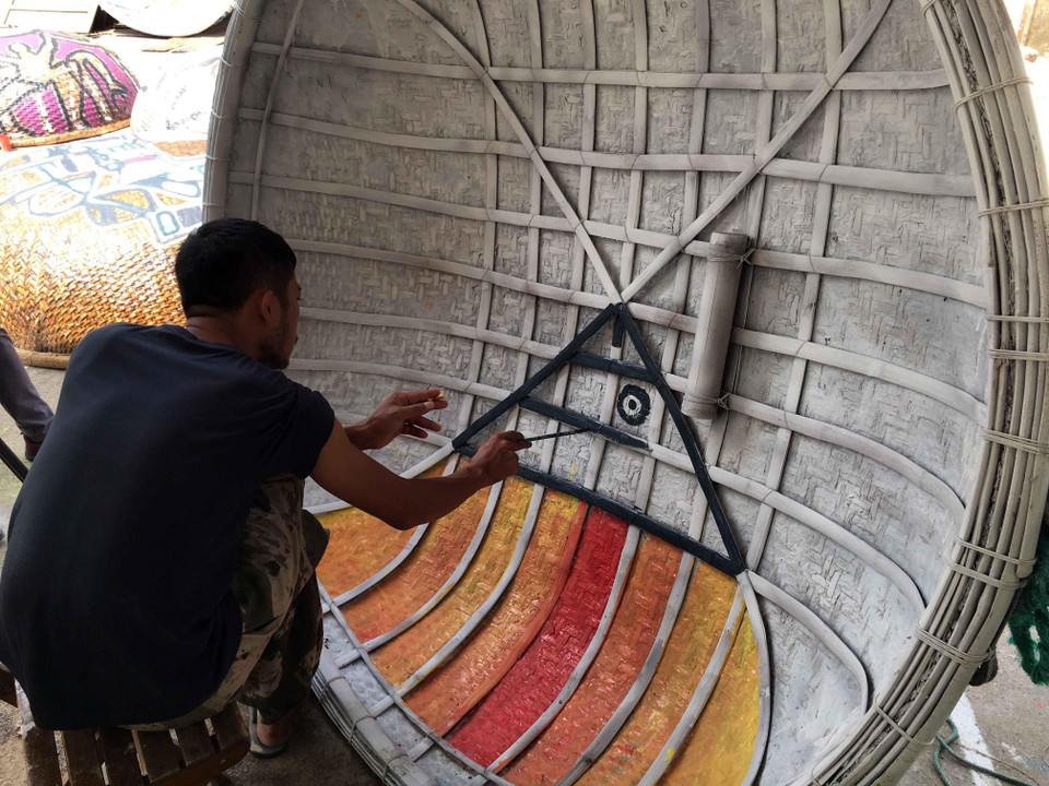 Những tác phẩm hội họa nhiều màu sắc, độc đáo được các họa sỹ thể hiện trên những chiếc thuyền thúng. (Ảnh: Đỗ Trưởng/TTXVN)