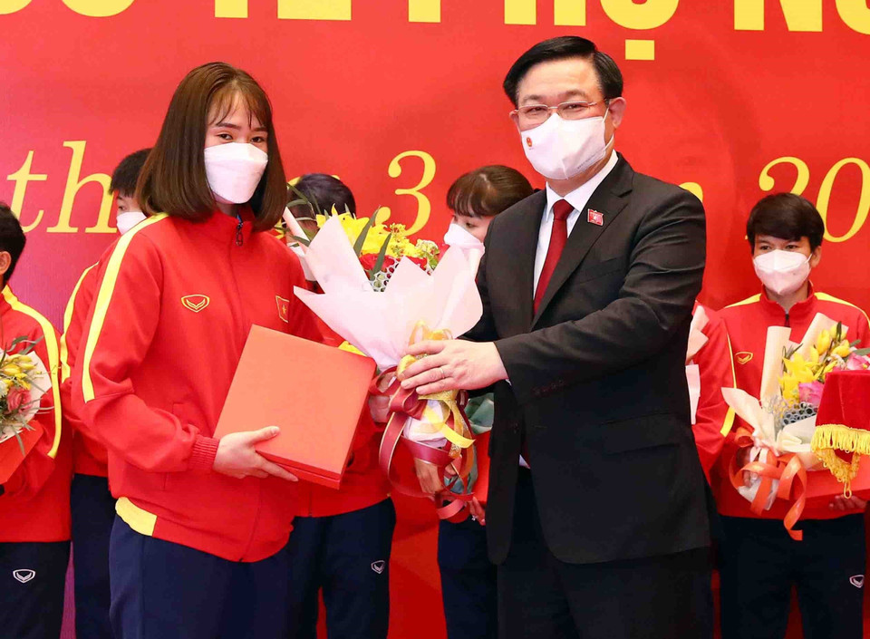 Chủ tịch Quốc hội Vương Đình Huệ tặng hoa và quà chúc mừng các nữ cầu thủ. (Ảnh: Phạm Kiên/TTXVN)