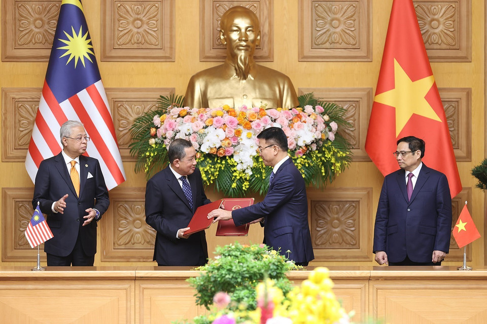 Bộ trưởng Bộ Tư pháp Lê Thành Long và Tổng Chưởng lý Malaysia Tan Sri Idrus Bin Harun trao đổi Bản ghi nhớ giữa Chính phủ Việt Nam và Chính phủ Malaysia về hợp tác pháp luật. (Ảnh: Dương Giang/TTXVN)