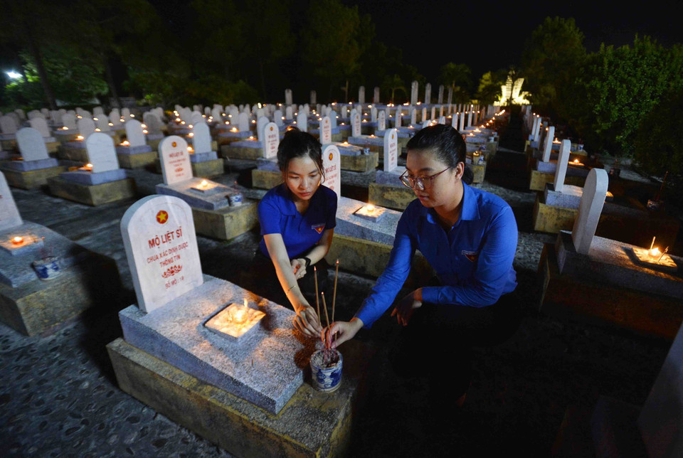 Đoàn viên thanh niên Khối các Cơ quan Trung ương thắp nến tri ân các Anh hùng Liệt sỹ tại Nghĩa trang Liệt sỹ Quốc gia Đường 9. (Ảnh: Minh Đức/TTXVN)