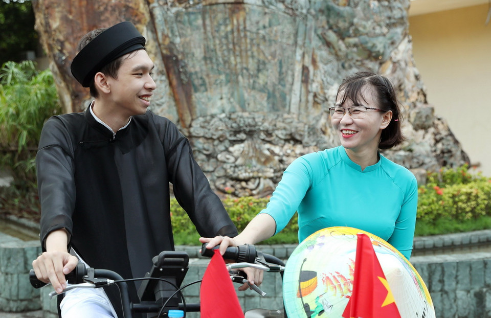 Hai bạn trẻ hạnh phúc trong tà áo dài. (Ảnh: Quốc Khánh/ TTXVN)