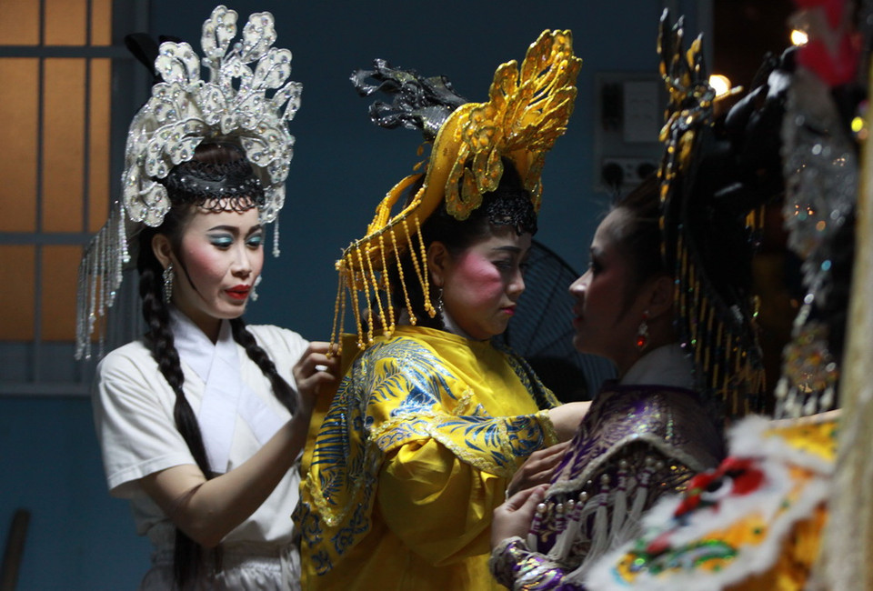 Nghệ sỹ hát bội hóa trang và chuẩn bị trang phục cho vai diễn. (Ảnh: Phương Vy/TTXVN)