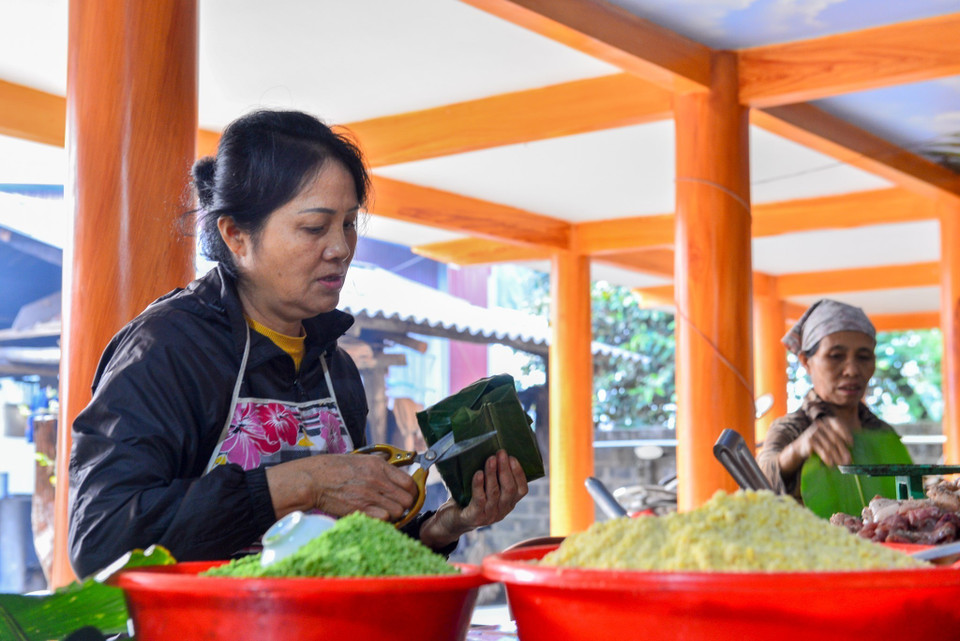 Sau khi gói, những phần lá thừa sẽ được cắt tỉa gọn gàng. (Ảnh: Nam Thái/TTXVN)