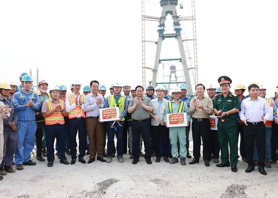 Thủ tướng Phạm Minh Chính tặng quà, động viên kỹ sư, công nhân thi công Dự án cầu Mỹ Thuận 2. (Ảnh: Dương Giang/TTXVN)