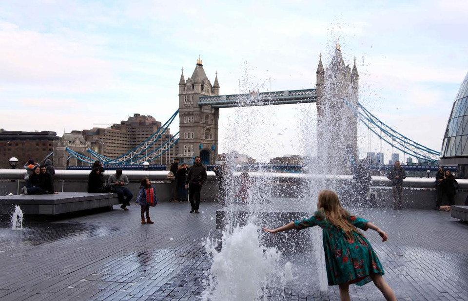 Vui đùa với đài phun nước gần Cầu tháp London. (Ảnh: Như Mai/Vietnam+)