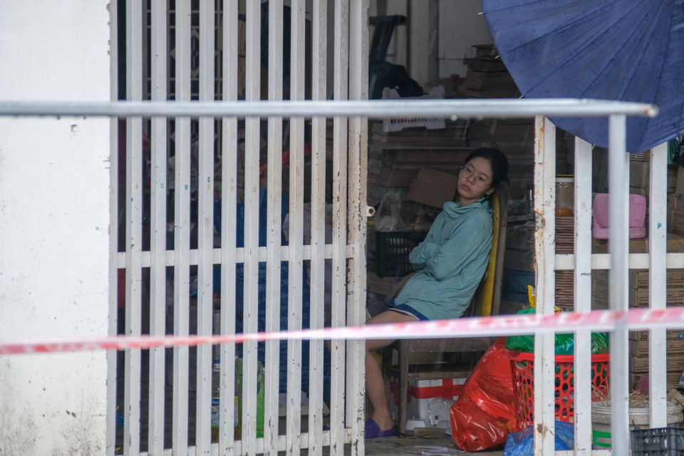 Bé gái ở căn nhà số 825 đường Bùi Hữu Nghĩa, phường Long Hòa, quận Bình Thủy ngồi bên đống vật dụng của gia đình sau khi nhà bị sạt lở. (Ảnh: Thanh Liêm/TTXVN)