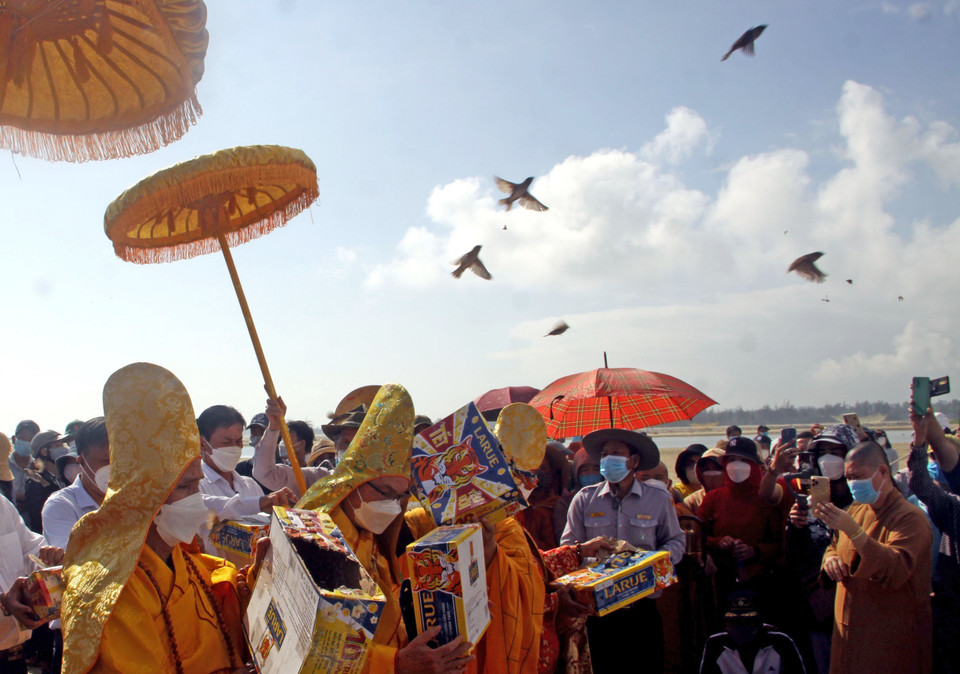Các tăng ni, Phật tử cùng bà con nhân dân thả chim phóng sanh tại lễ tưởng niệm, cầu siêu cho các nạn nhân vụ chìm canô. (Ảnh: Trịnh Bang Nhiệm/TTXVN)
