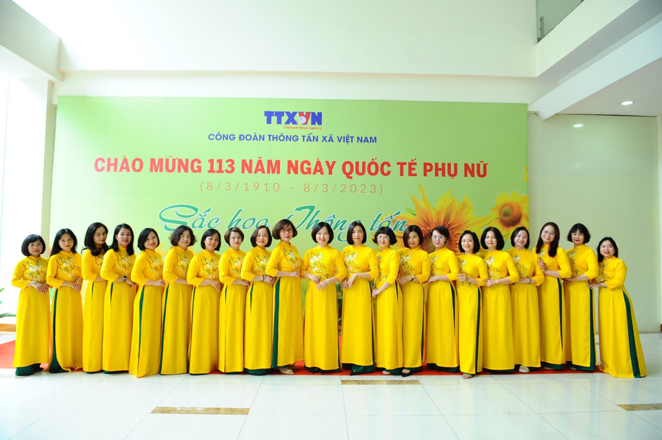 Nữ biên tập viên, họa sĩ của Trung tâm Thông tin tư liệu và Đồ họa thướt tha trong đồng phục áo dài. (Ảnh: Minh Đức/TTXVN)