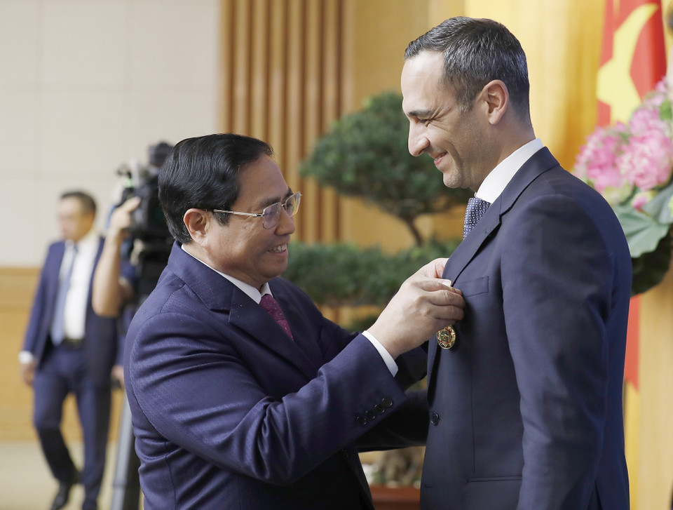 Thủ tướng Phạm Minh Chính trao Huy chương Hữu nghị của Chủ tịch nước cho ông John Paul Pullicino Said Anthony, nguyên Tổng giám đốc Công ty TNHH Pfizer Việt Nam. (Ảnh: Dương Giang/TTXVN)
