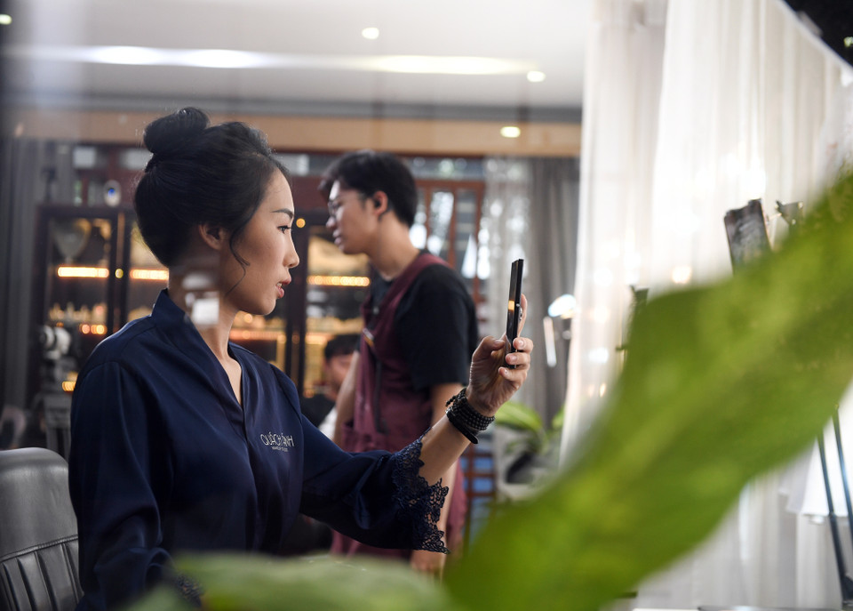 Đối tác tài xế Nguyễn Thị Phương Hoa khá bất ngờ và nhanh chóng ghi lại hình ảnh của mình sau khi chiếc gương trang điểm được mở ra. Lần trang điểm trước đây của chị cũng đã gần 1 năm. (Ảnh: CTV/Vietnam+)