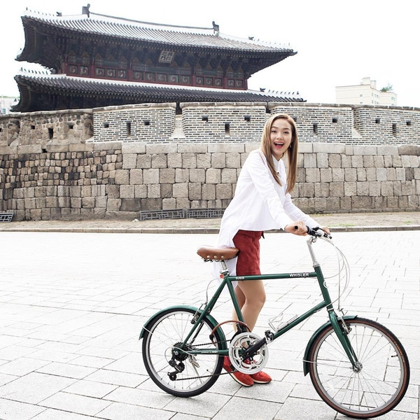  Minh Hằng "quậy" cùng xe đạp trong trang phục khá thoải mái gồm áo sơmi trắng dáng dài và quần shorts tiệp màu giày sneakers năng động
