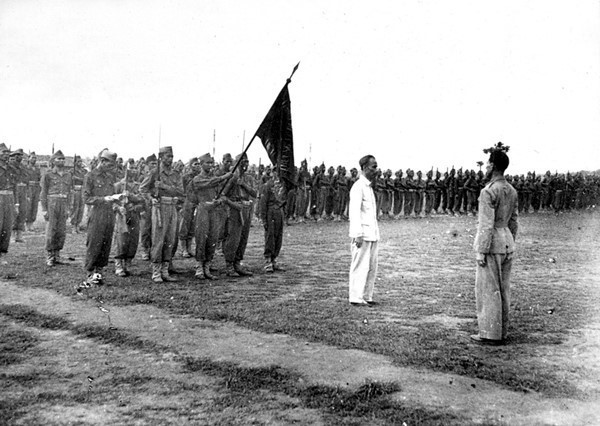 Chủ tịch Hồ Chí Minh đến thăm và trao tặng Trường Võ bị Trần Quốc Tuấn lá cờ thêu sáu chữ vàng “Trung với nước, hiếu với dân” tại Sơn Tây, ngày 26/5/1946. (Ảnh: Tư liệu/TTXVN)