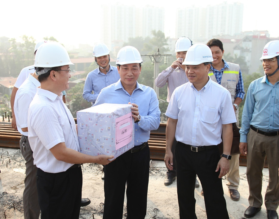 Lãnh đạo Bộ Giao thông Vận tải tặng quà cho phía Tổng thầu Trung Quốc trong buổi hợp long dự án. (Ảnh: Doãn Đức/Vietnam+)