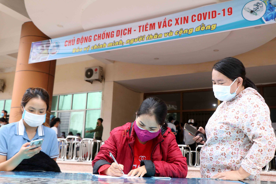 Người dân đến tiêm khai thông tin cá nhân và y tế trước khi tiêm vaccine phòng COVID-19. (Ảnh: Trung Kiên/TTXVN)