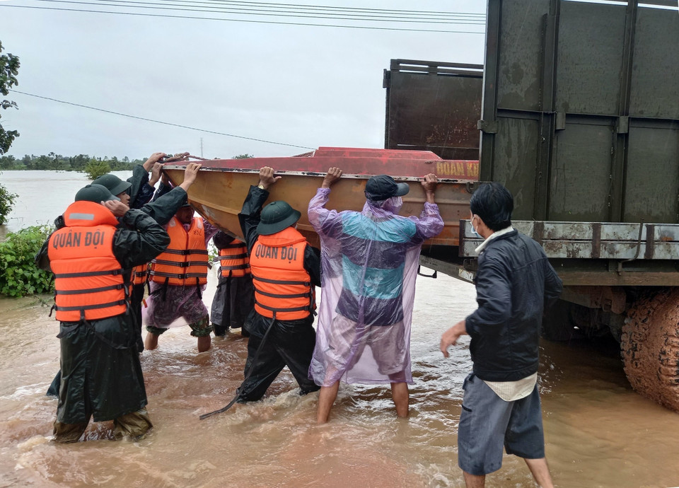 Lực lượng quân đội huy động canô ứng cứu người dân bị mắt kẹt trong nước lũ. (Ảnh: TTXVN phát)