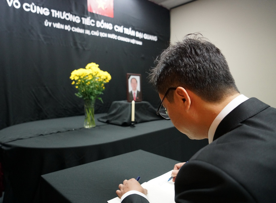 Tổng Lãnh sự Việt Nam tại Sydney Trịnh Đức Hải thay mặt cán bộ, nhân viên Tổng Lãnh sự quán ghi sổ tang Chủ tịch nước Trần Đại Quang. (Ảnh: TTXVN)