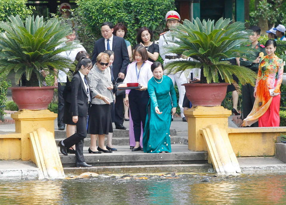 Bà Nguyễn Thị Hiền, Phu nhân Chủ tịch nước Trần Đại Quang và bà Lynne Cosgrove, Phu nhân Toàn quyền Australia Peter Cosgrove cho cá ăn tại Ao cá Bác Hồ trong Khu di tích Chủ tịch Hồ Chí Minh. (Ảnh: Lâm Khánh/TTXVN)