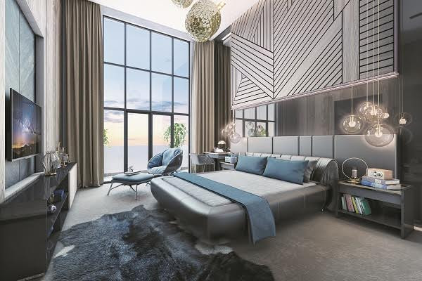 Phòng ngủ đẳng cấp với màu xanh dương của chăn, gối, ghế sofa hòa với sắc xanh lá bên ngoài cửa sổ. Hai tone màu xanh hài hòa tạo nên sự kết nối tuyệt vời giữa nhà và thiên nhiên.