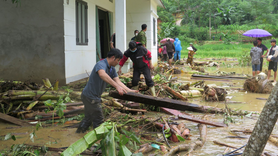 Người dân địa phương nỗ lực tìm người thân bị nạn sau lũ dữ. (Ảnh: Hồng Ninh/TTXVN)