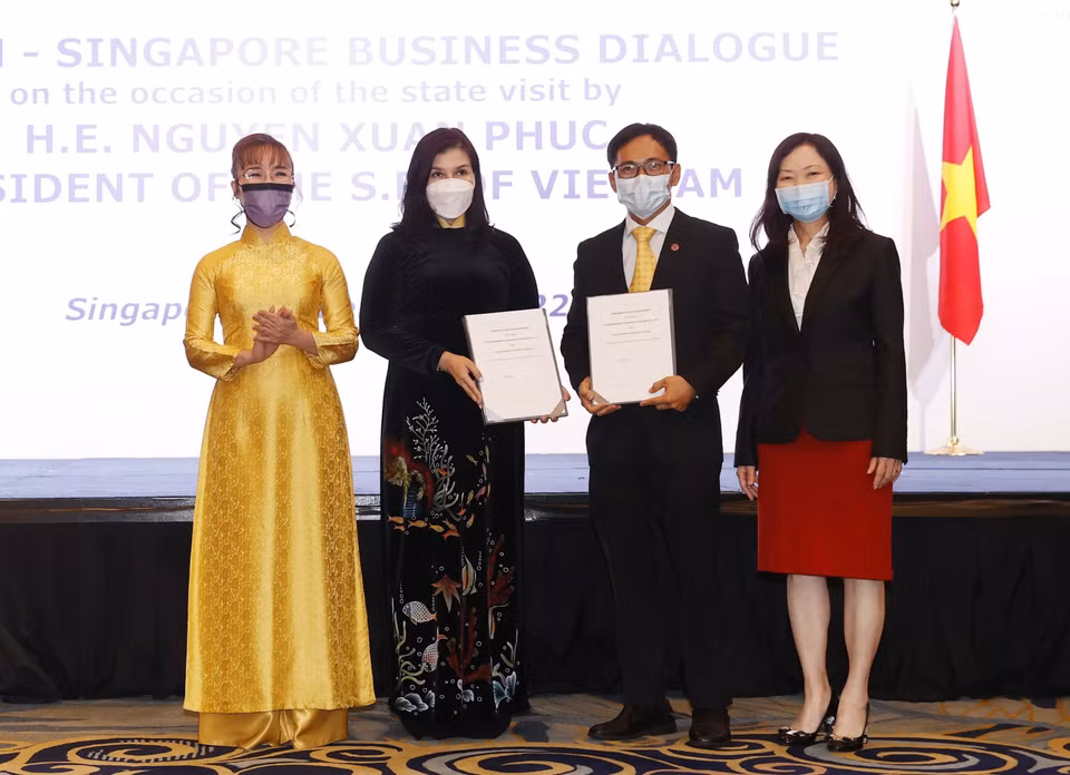 Doanh nghiệp hai nước trao đổi các hợp đồng, thỏa thuận hợp tác tại cuộc Đối thoại doanh nghiệp Việt Nam-Singapore. (Ảnh: Thống Nhất/TTXVN)
