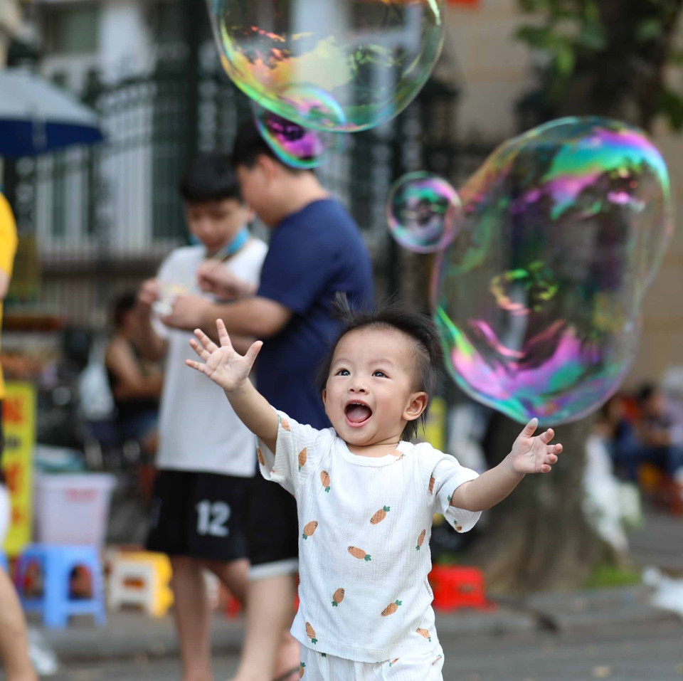 Trẻ em thích thú với bong bóng trong không gian đi bộ hồ Hoàn Kiếm. (Ảnh: Thanh Tùng/TTXVN)