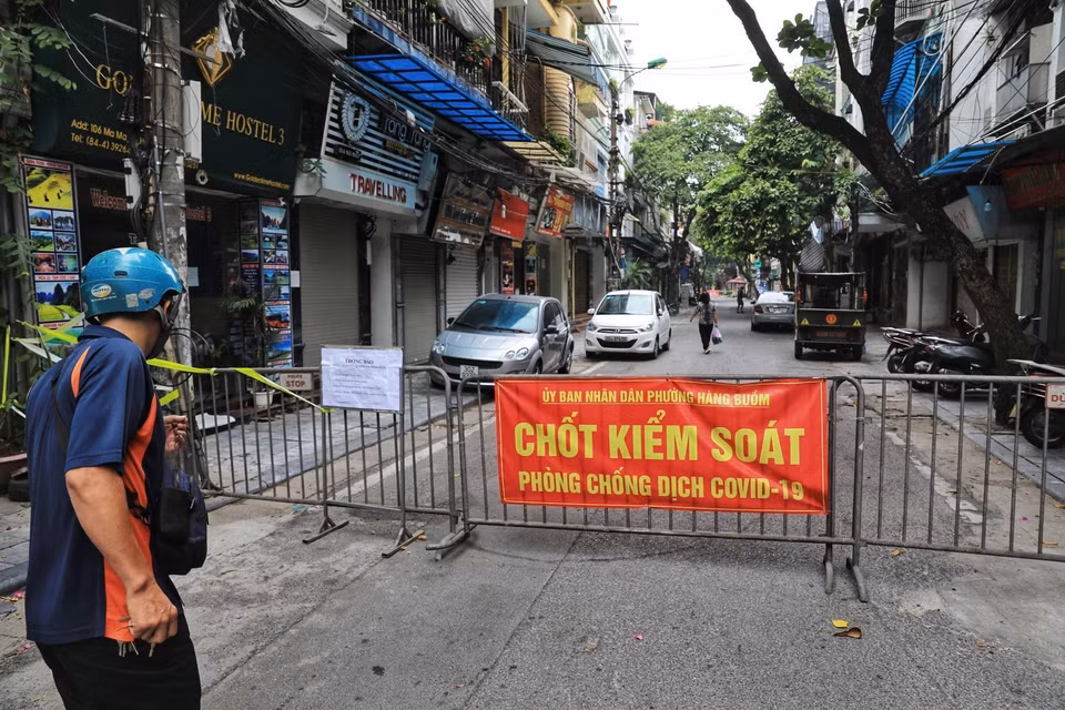 Phố Mã Mây lập "chốt cứng" cả 2 đầu phố để không cho người lạ, khách vãng lai đi vào, đồng thời dán thông báo người dân đi vòng đường khác qua chốt "mềm" để lực lượng chức năng kiểm tra giấy tờ. (Ảnh: Thành Đạt/TTXVN)