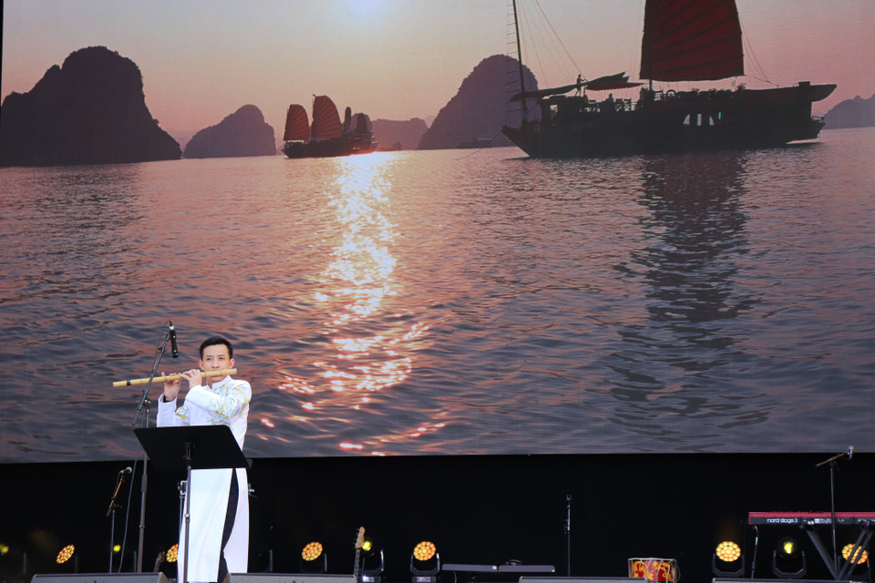 Các nghệ sỹ Việt Nam trình diễn với nền sân khấu phía sau là hình ảnh của vịnh Hạ Long.