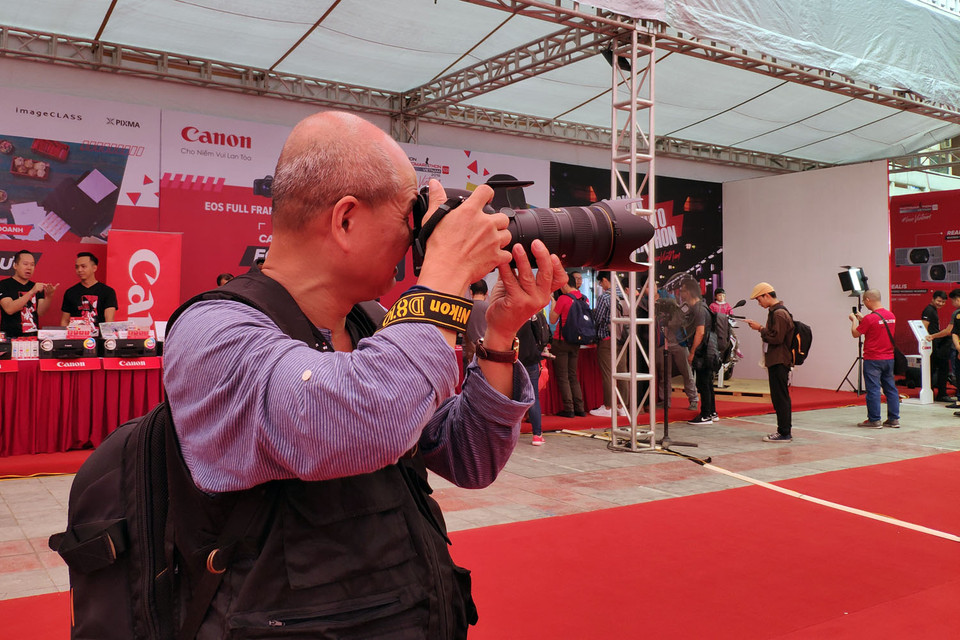 Một thí sinh cao tuổi tranh thủ 'săn' khoảnh khắc ngay tại nơi phát động cuộc thi.