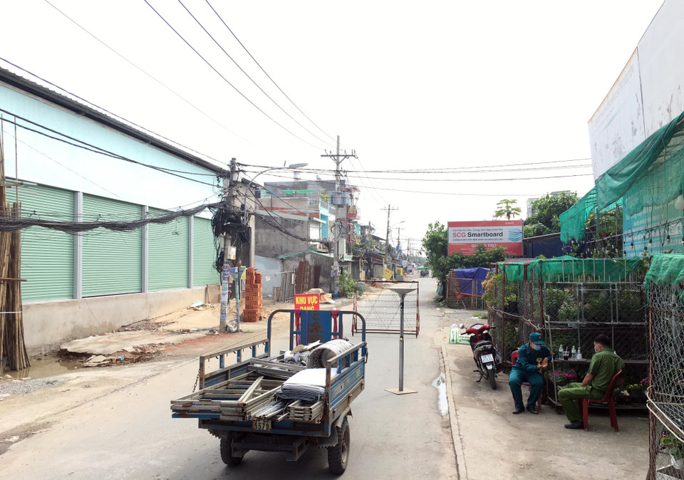 Lực lượng chức năng chốt chặn đầu đường TL19, đoạn giao đường Hà Huy Giáp (phường Thạnh Lộc, Quận 12, Thành phố Hồ Chí Minh). (Ảnh: Tiến Lực/TTXVN)