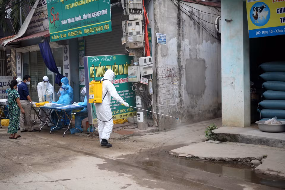 Phun thuốc khử khuẩn sau khi kết thúc công việc lấy mẫu xét nghiệm tại thôn Hạ Lôi (xã Mê Linh, huyện Mê Linh). (Ảnh: Danh Lam/TTXVN)