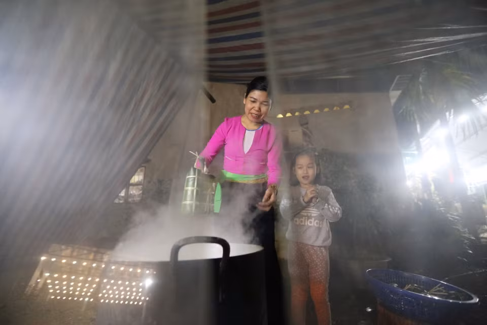Sau khi gói xong, xếp bánh vào nồi, lót lá dong xuống đáy và trên cùng để không bị cháy và giữ được hơi. Bánh được luộc trong khoảng 12-15 giờ, sau khi luộc xong, rửa bánh trong nước lạnh cho sạch nhựa, để ráo hoặc túm lại treo lên. (Ảnh: Trọng Đạt/TTXVN)